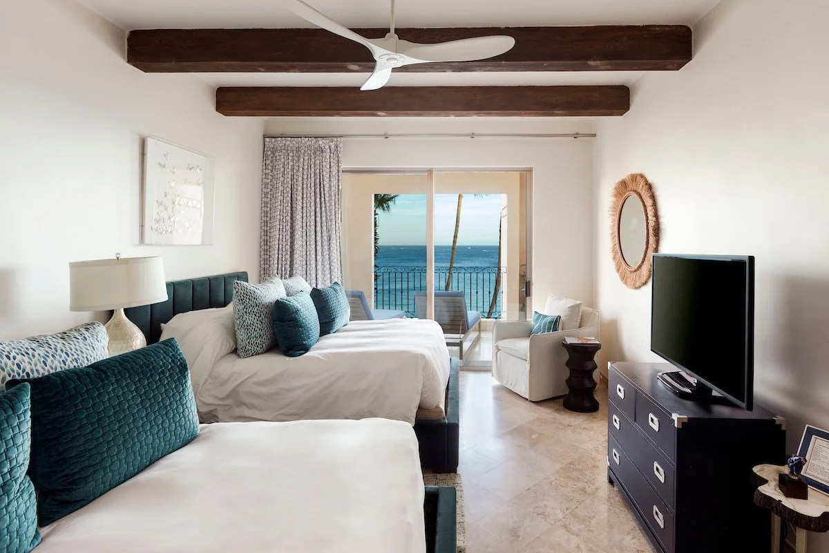 Guest bedroom with two queen beds and ocean view