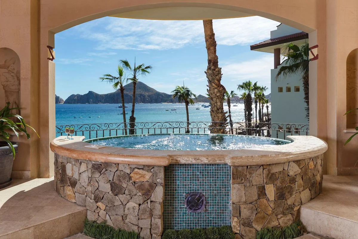 Custom stone jacuzzi with archway and mountain views