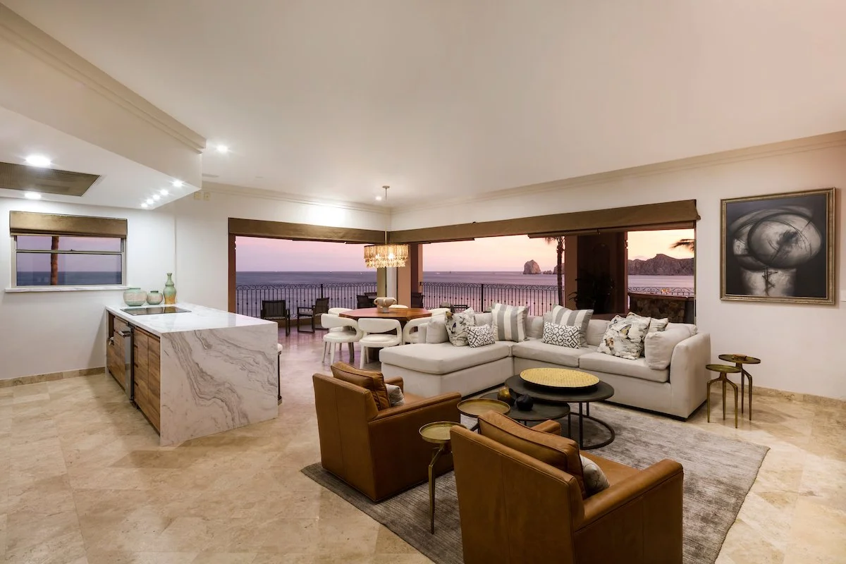 Spacious living room with floor-to-ceiling windows and sunset view